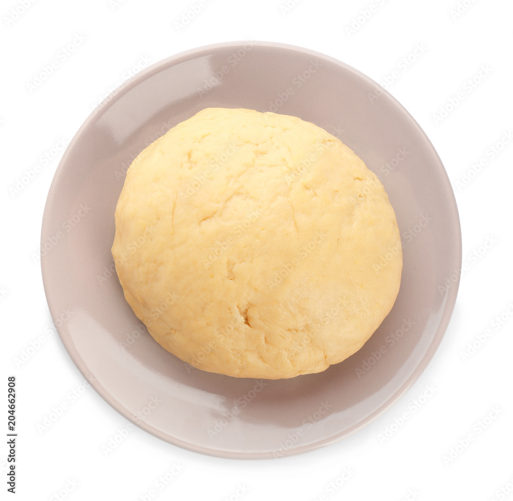 Plate with raw dough on white background, top view Plate with raw dough on white background, top view