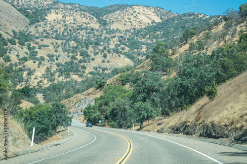 Picturesque road in the arid mountains of Sierra Nevada, California. Natural prairies of the USA