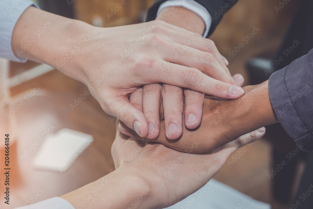 Group of diverse hand together joining concept during a meeting in the office for business cooperation. Group of diverse hand together joining concept during a meeting in the office for business cooperation.