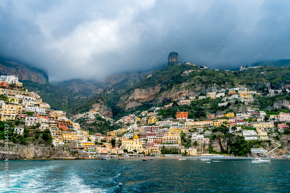 Panoramic view of beach and colorful buildings  in Positano town at Amalfi Coast, Italy.