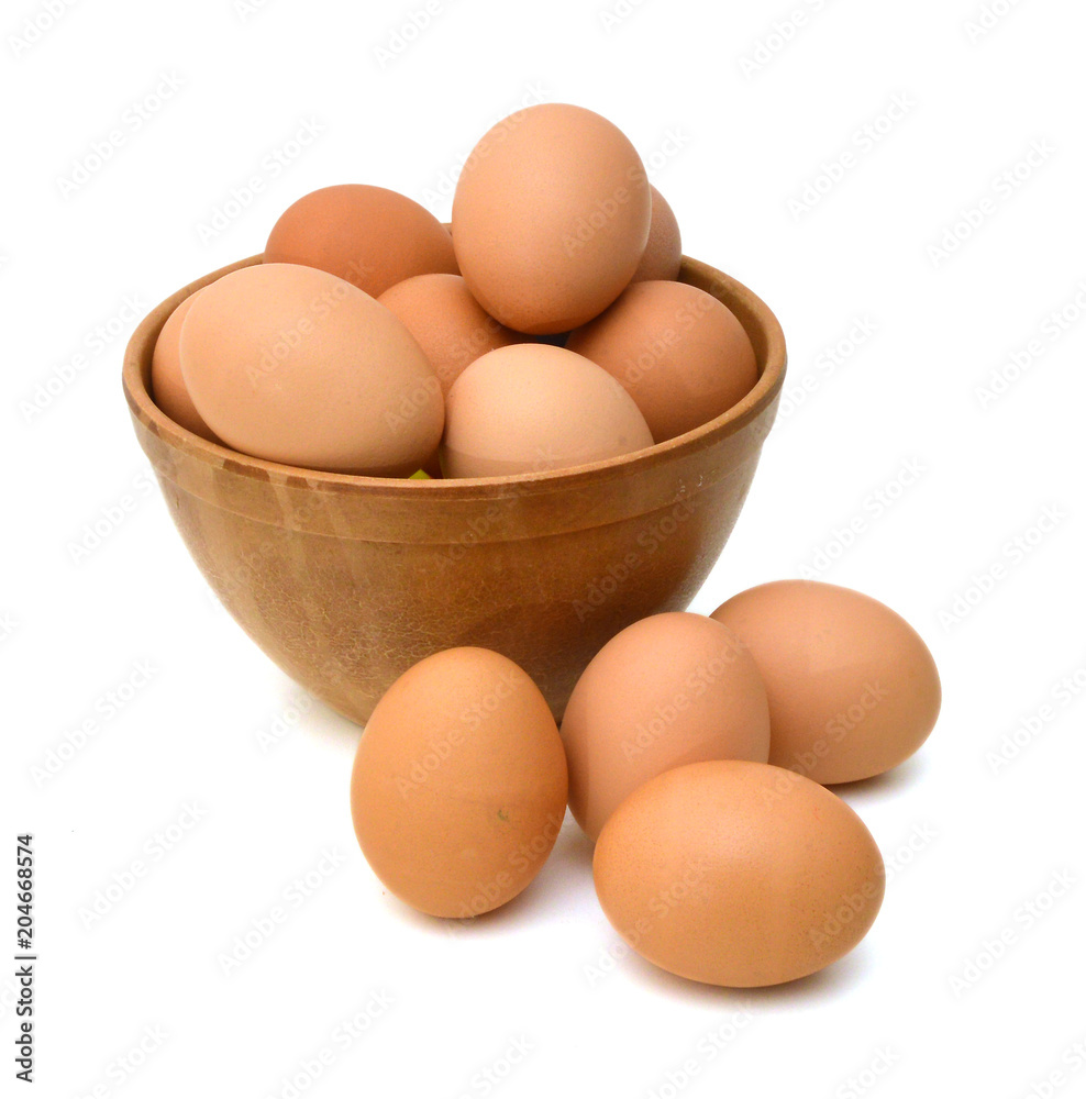 wood bowl with brown eggs over the white background wood bowl with brown eggs over the white background