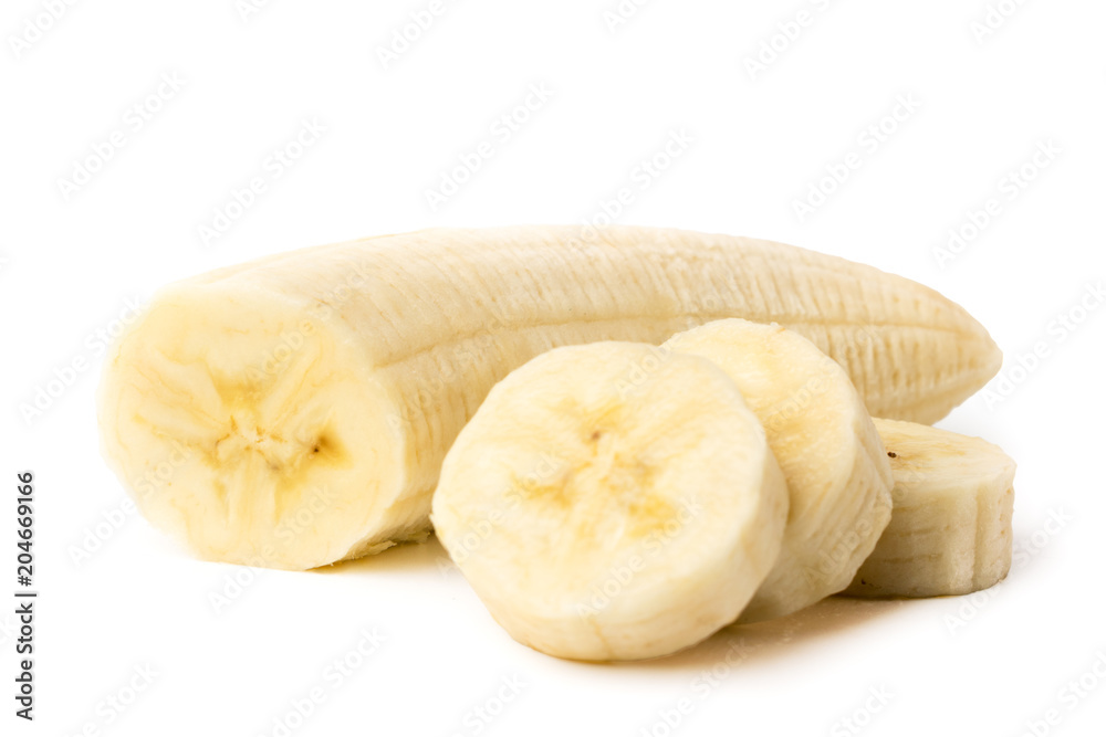 Ripe banana peeled cut into pieces on a white, closeup. Ripe banana peeled cut into pieces on a white, closeup.