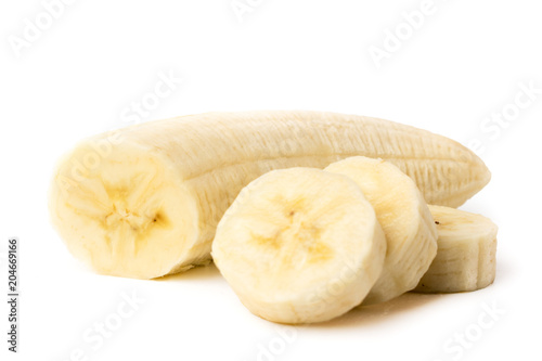 Ripe banana peeled cut into pieces on a white, closeup.