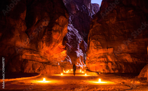 The girl standing in the Siq over the night, Petra, Jordan.