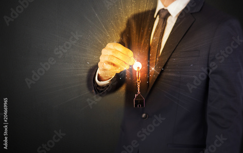 Formal man hand over shiny keys with dark background   © ra2 studio