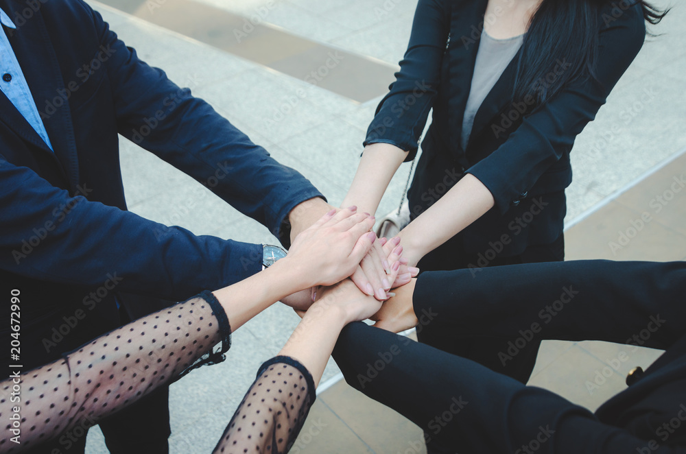 teamwork concept of diverse multiethnic business people with group hands put and stack holding with power team for relationship and success together. Collaboration, harmonious working concept.