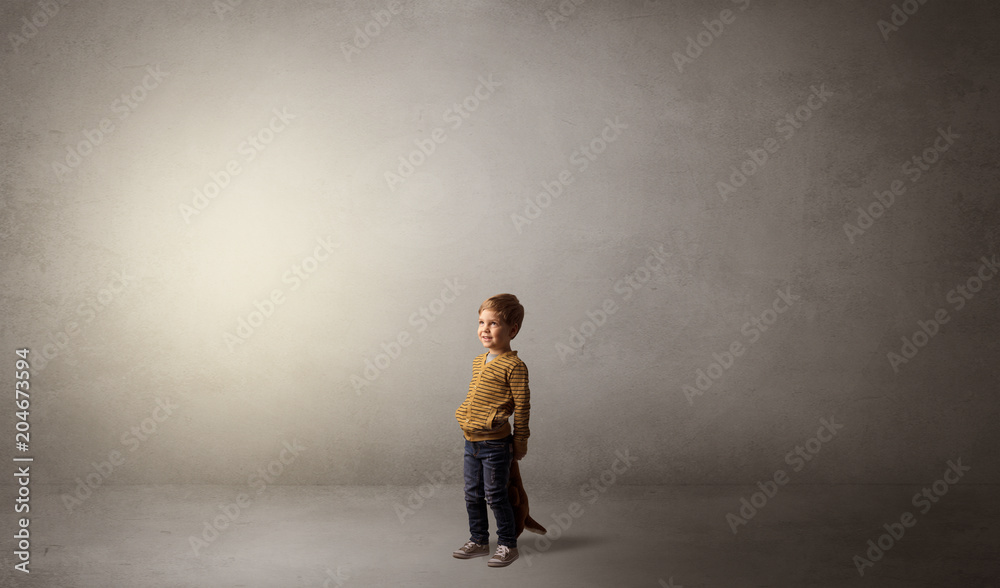 Little waggish kid staying alone in a big empty room with his plush
Little waggish kid staying alone in a big empty room with his plush