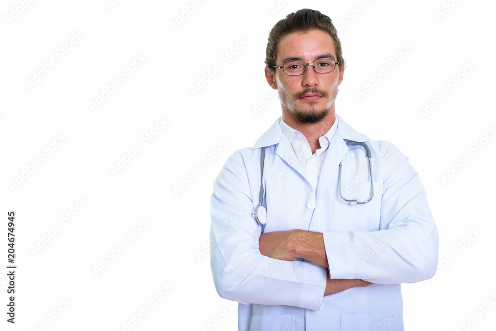 Studio shot of young handsome man doctor with arms crossed isola Studio shot of young handsome man doctor with arms crossed isola