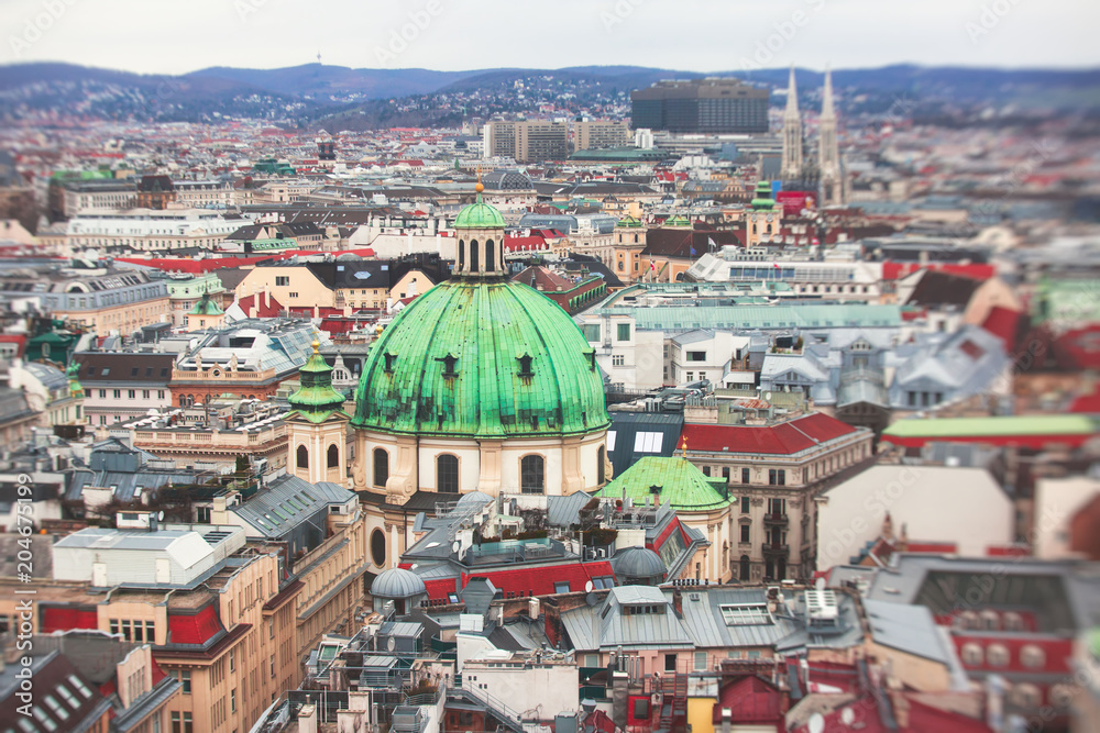 Beautiful super-wide angle aerial view of Vienna, Austria, with old town Historic Center and scenery beyond the city, shot from observation deck of Saint Stephens's Cathedral