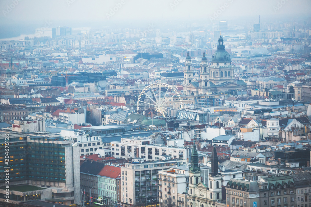 Beautuful super-wide angle aerial view of Budapest, Hungary, with Danube river and scenery beyond the city, seen from observation point of Gellert Hill Beautuful super-wide angle aerial view of Budapest, Hungary, with Danube river and scenery beyond the city, seen from observation point of Gellert Hill