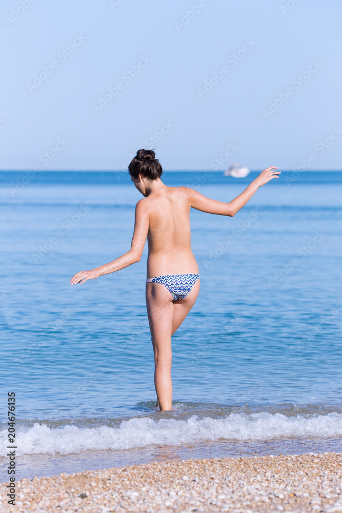 Girl entering in sea water in morning time