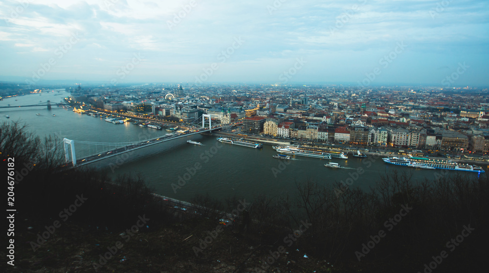 Beautuful super-wide angle aerial view of Budapest, Hungary, with Danube river and scenery beyond the city, seen from observation point of Gellert Hill