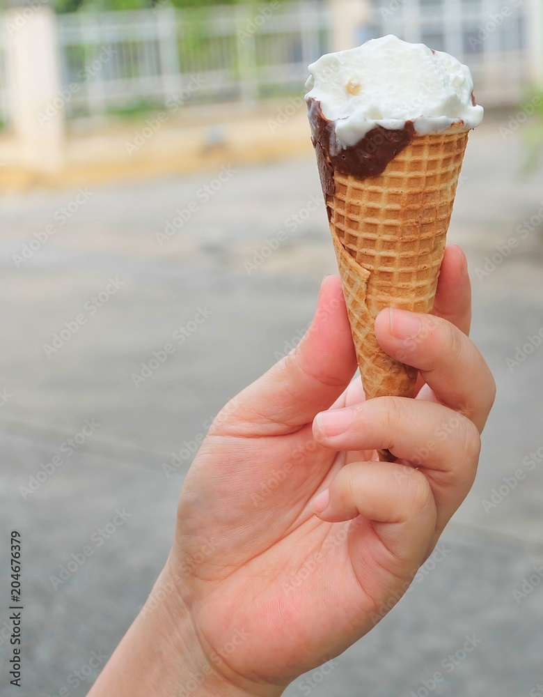 Hand Holding Ice Cream Cones with Chocolate Hand Holding Ice Cream Cones with Chocolate