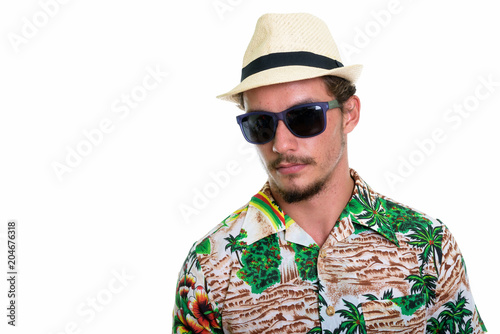 Studio shot of young handsome tourist man wearing sunglasses iso