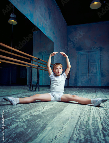 boy ballet dancer doing exercise at  dance class