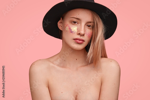 Headshot of beautiful female with naked body, demonstrates her natural beauty...