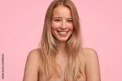 People, natural beauty and positive emotions concept. Pleased young female wi...