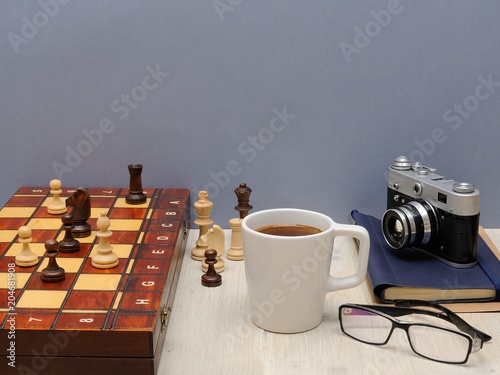 Postcard Father's Day. Father's things, a cup of coffee, chess pieces and the concept of love for parents.
