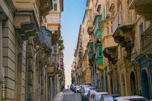 Parked cars on narrow street photo