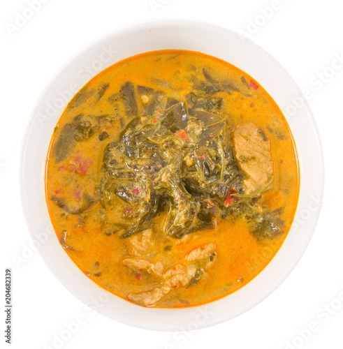 Top View Coconut Milk Curry with Cassia Leaves on White photo