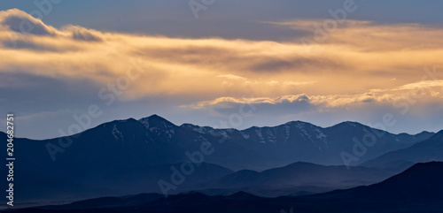 Panorama of the mountains on a hazy, but colorful sunset evening © Boyce