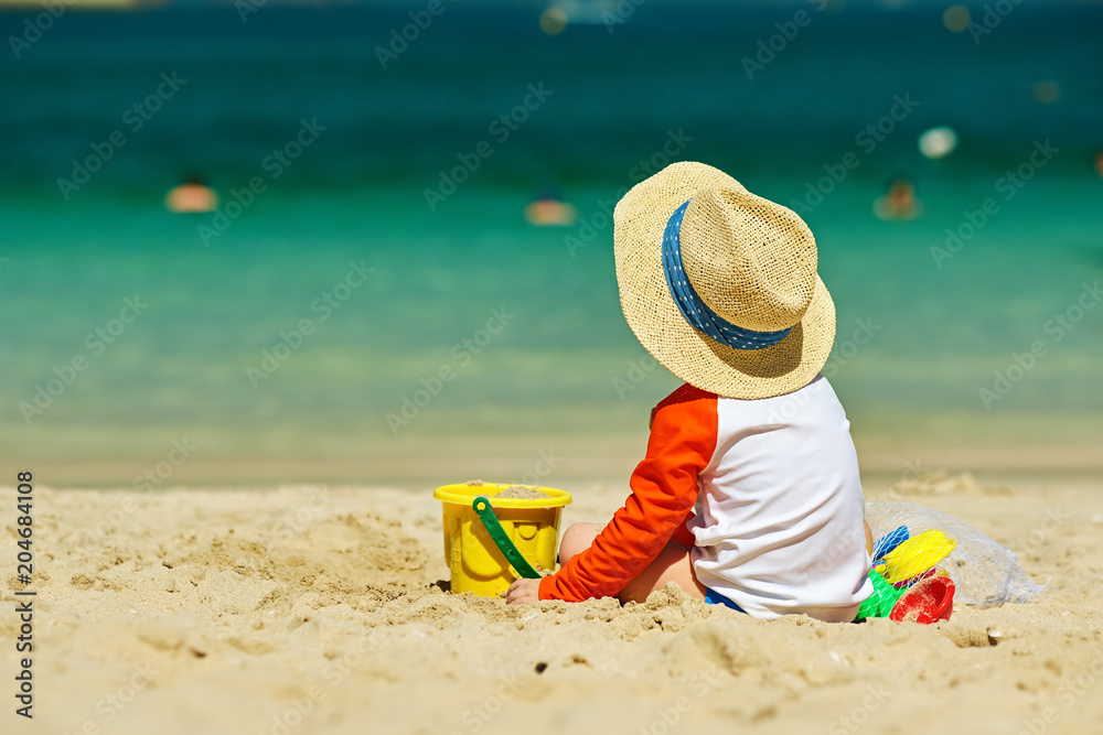 Two year old toddler playing on beach Two year old toddler playing on beach