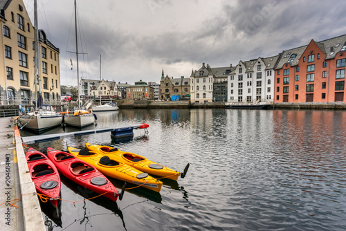 Kayaks on the water in coastal town Alesund, Norway photo