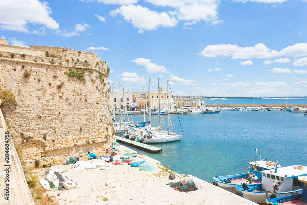 Gallipoli, Apulia - Sailing boats at the harbor near the historical city wall