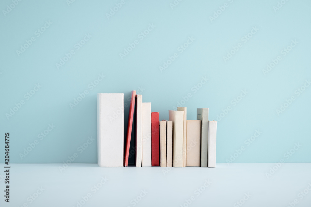 Fototapeta premium Stack of miniature books on a shelf.
