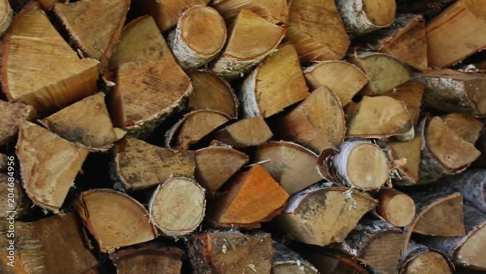 Chopped birch firewood. A pile of firewood. Woodchopping. Shredded and stacked wood Chopped birch firewood. A pile of firewood. Woodchopping. Shredded and stacked wood