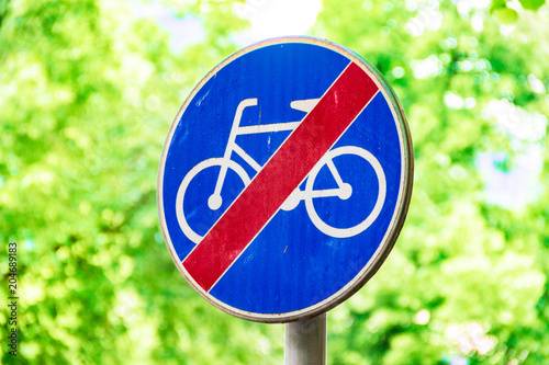 Signs for cyclists, road sign against a background of green trees