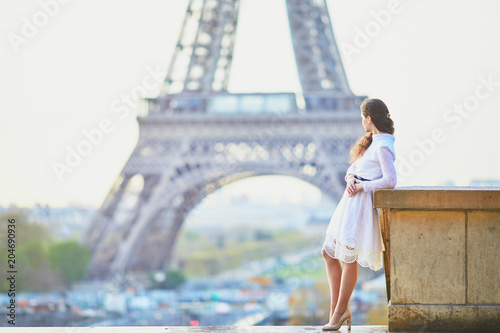 Woman in white dress near the Eiffel tower in Paris, France © Ekaterina Pokrovsky