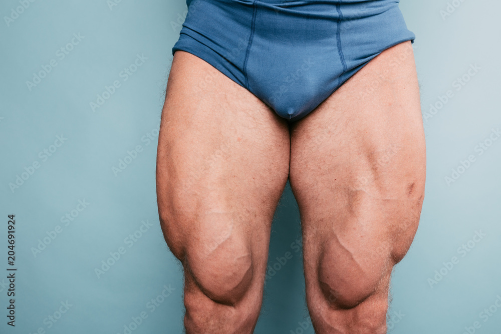 Foto Stock body parts: muscular pumped legs of bodybuilder. man posing in  underwear: boxer briefs. fitness trainer shows a relief of muscles after  exercise. healthy knees and clean skin | Adobe Stock