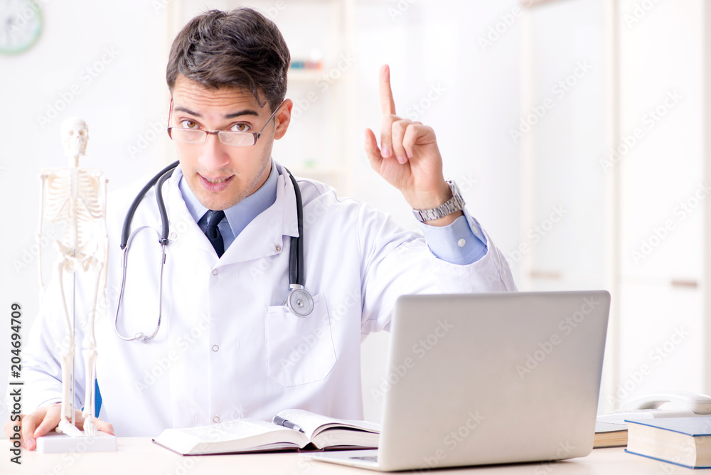 Doctor explaining human body on skeleton Doctor explaining human body on skeleton