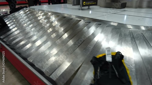 Receiving baggage at the airport.	Passengers are waiting for their luggage after arrival.