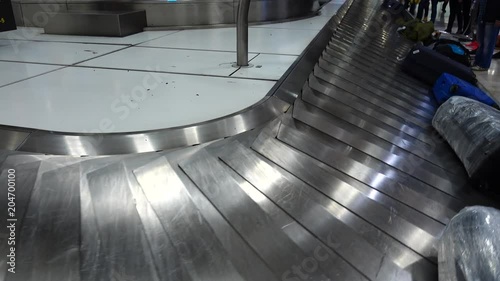 Receiving baggage at the airport.	Passengers are waiting for their luggage after arrival.