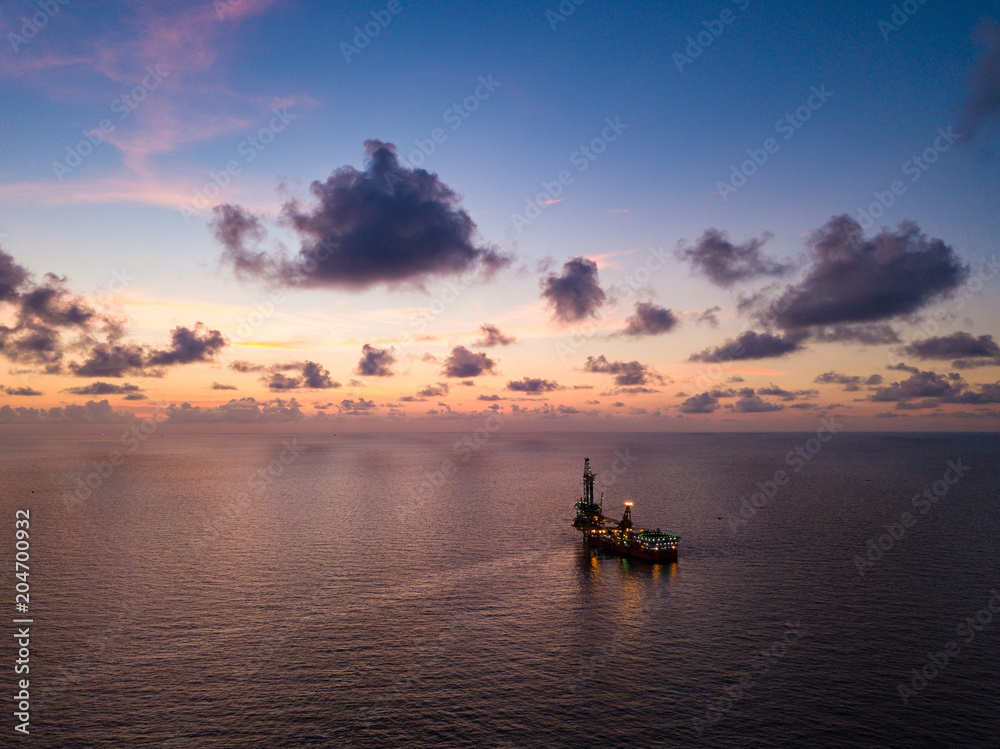 Aerial View of Tender Drilling Oil Rig (Barge Oil Rig) in The Middle of The Ocean at Sunset Time Aerial View of Tender Drilling Oil Rig (Barge Oil Rig) in The Middle of The Ocean at Sunset Time