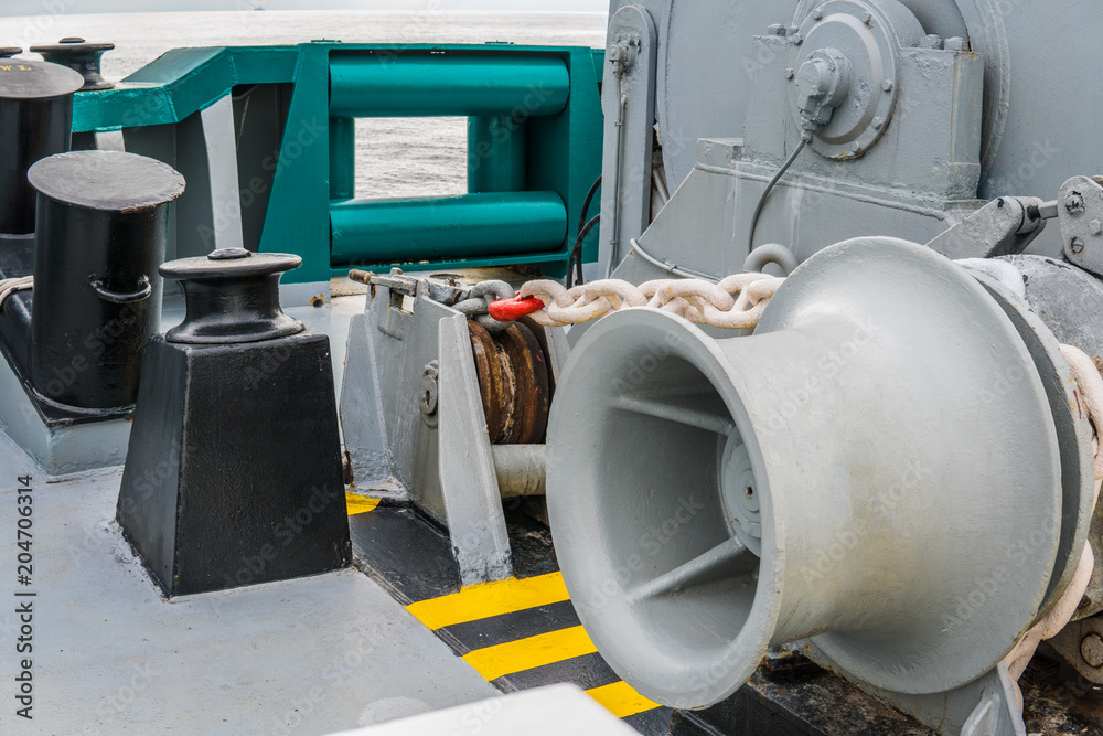 mooring equipment of ship. Empty winch. All gears are in good order. Marine sea job. Port on background mooring equipment of ship. Empty winch. All gears are in good order. Marine sea job. Port on background