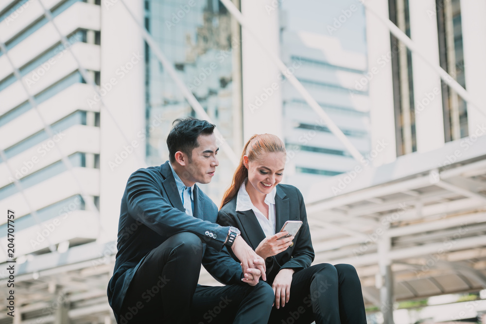 Group people wearing formal suit sitting on stair of center capital city and there text messaging to partner Group people wearing formal suit sitting on stair of center capital city and there text messaging to partner