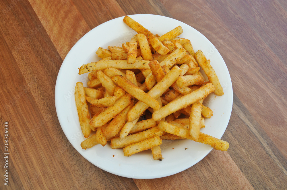 Spice golden french fries on a plate Spice golden french fries on a plate