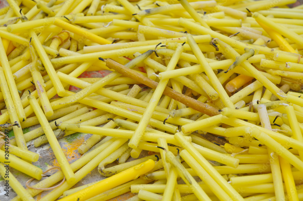 Close up of yellow candles for worshiping in temple Close up of yellow candles for worshiping in temple