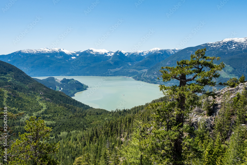 view of Howe Sound and far away snow covered mountains on top of  Stawamus Chief