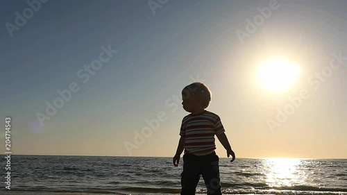 little 1 + year boy at sea coast silhouette panoramic shot photo