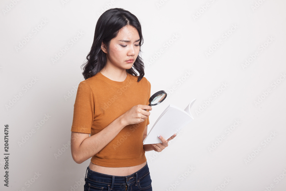 Asian woman with a book and magnifying glass. Asian woman with a book and magnifying glass.