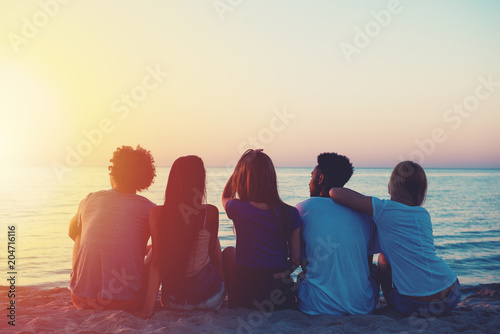 Group of happy friends relaxing at the beach photo