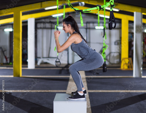 woman working out jumping on fit box