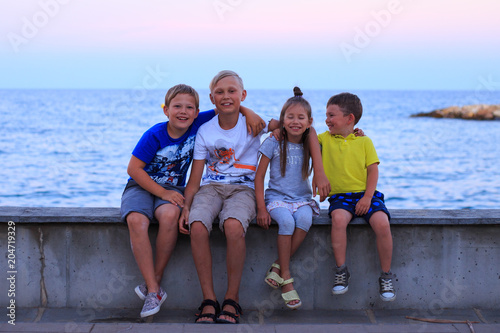 Four children on beach vocation. Young family on vacation have a lot of fun.