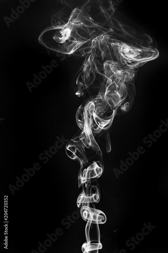 abstract fragment movement of burn white smoke on black background.