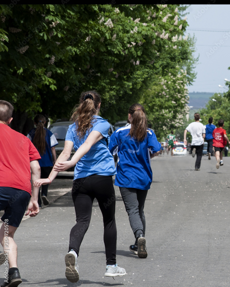 Obraz premium дети бегущие по асфальту эстафета