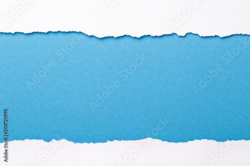 Fotografija Ripped white paper with colored background with space for text